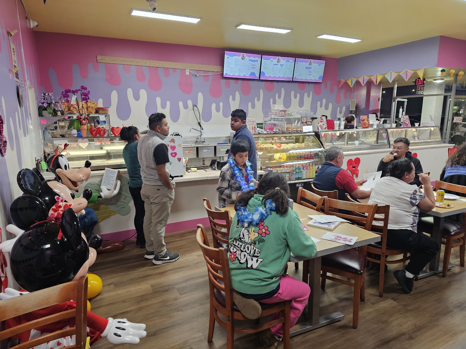 Families enjoying paletas inside Mia's Paletería